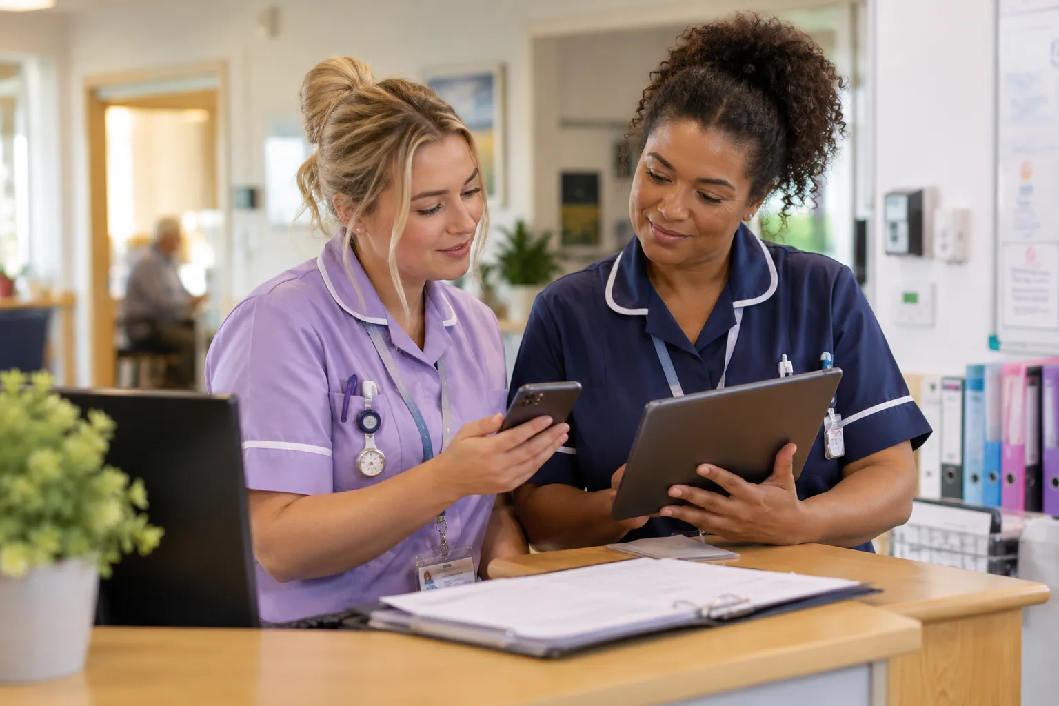 Care staff preparing a calm, organised handover in a tidy meeting area